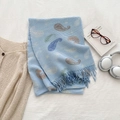 Light blue paisley scarf with crinkle texture and fringe tassels laid on a soft background - Sky Blue