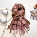 Thick pink and brown plaid scarf with long tassels on a cozy white knit background - Pink