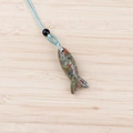 Carved unakite gemstone fish pendant with light blue braided cord and black bead accent - Unakite