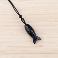 Polished black obsidian fish pendant necklace with intricate scale texture and woven cord - Obsidian