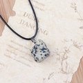 Dalmatian Jasper cubic stone pendant with black wax cord on a vintage paper background - Dalmatian Jasper