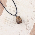 Natural tiger eye stone pendant necklace with raw texture on vintage background paper - Tiger's Eye
