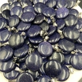 Macro shot of circular blue sand stone pendants with glittering stars and silver clips - Blue Sandstone (Synthetic)