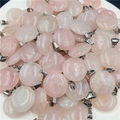 Dettaglio macro di ciondoli a ciambella in quarzo rosa naturale con ganci in argento - Quarzo rosa