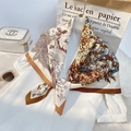 Floral silk square scarf with brown earth tones tied on white shirt for elegant look - Khaki