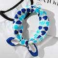 Elegant white silk scarf with blue heart prints shown styled on a simple t-shirt - 53*53cm / Heart Sky Blue