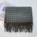 Plaid Christmas scarf in dark brown and teal with long fringe, folded on textured background - Peacock Green Plaid