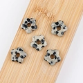 Five Dalmatian Jasper flower-shaped beads with black spots on a natural bamboo board - Dalmatian Jasper (Single Bead)