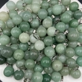 Spherical green aventurine stone pendants with silver metal clasps on white background - Green Aventurine