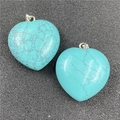 Detail showing two 30mm heart-shaped turquoise stone pendants with silver metal clasps - Synthetic Blue Turquoise