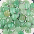 Bulk round green aventurine stone donut pendants with silver metal bails on white background - Green Aventurine