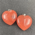 Macro shot of two heart-shaped orange crystal pendants with natural ice textures - Watermelon Red (Synthetic)