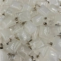 Close-up of bulk rectangular translucent white crystal pendants with silver bails - White Quartz