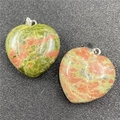 Macro shot of 30mm heart-shaped Unakite stone pendant with a silver metal clasp hook - Unakite