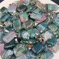 Macro detail of rectangular moss agate stone pendants with polished mineral textures - India Agate
