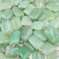 Macro view of stacked rectangular natural green quartz stone pendants with metal bails - Green Aventurine