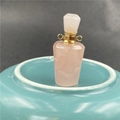 Detail of rose quartz perfume bottle pendant with faceted cut and gold metal neck collar - Rose Quartz