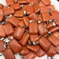 Macro shot of rectangular red goldstone pendants with sparkling glitter and silver clasps - Red Goldstone (Synthetic)