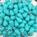 Detailed view of turquoise teardrop pendants with black vein patterns and silver clasps - Synthetic Blue Turquoise