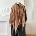Brown knit scarf with cute cat patterns and tassel trim displayed on a mannequin - Brown