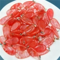 Bulk red and white teardrop stone pendants with silver clasps in a white bowl - Watermelon red