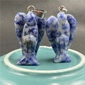 Detail of two angel-shaped natural blue sodalite pendants with silver metal clasps - Sodalite