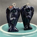 Macro shot of two blue sandstone angel pendants with sparkling metallic bail accents - Blue Goldstone (Synthetic)