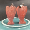 Detail of pink crystal angel pendants with polished finish and silver metal clasps - Rose Quartz