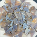 Macro view of triangular natural agate stone pendants with silver-colored metal bails - Grey Agate