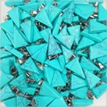 Macro detail of turquoise triangle pendants with silver bails and grey veins - Synthetic Blue Turquoise