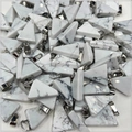 Macro shot of bulk triangle white howlite stone pendants with silver metal clasps - White Turquoise