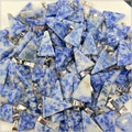 Close-up of bulk natural blue sodalite triangle pendants with silver metal bails - Blue Spot Stone