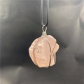 Macro detail of rose quartz raw stone pendant wrapped in silver wire with black cord - Silver Wire Wrapped Rose Quartz
