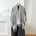 Grey cashmere-like scarf with white cat jacquard and tassels on a mannequin - Gray