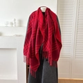 Red plaid cashmere feel scarf with fringe layered over a grey wool coat for winter - Red