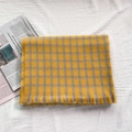 Soft yellow and grey geometric pattern knit scarf with fringe trim on white fabric - Yellow Figure-Eight Pattern
