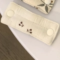 Fabric cable organizer in cream color with dark cherry print and white snap button - Quilted Cherry