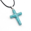 Teal turquoise cross pendant necklace with black cord and natural stone textures - Synthetic Blue Turquoise