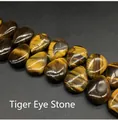 Macro view of polished teardrop tiger eye beads with golden stripes and cat eye effect - 13x18mm Tiger's Eye