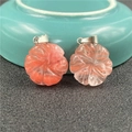 Macro shot of two strawberry quartz flower pendants with silver clasps on black surface - Watermelon Red (Synthetic)