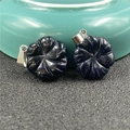 Macro detail of blue sandstone flower pendants with shimmering gold speckles on silver clips - Blue Sandstone (Synthetic)