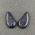 Macro view of blue sandstone angel wing charms with sparkling texture for DIY jewelry - Blue Goldstone (Synthetic)