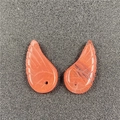 Detailed view of translucent orange wing-shaped charms with fine engraved feather texture - Watermelon Red (Synthetic)