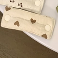 Fabric strap protectors for baby gear featuring heart and cherry prints with white snaps - Quilted Heart