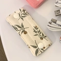Floral fabric cable organizer with snap buttons for headphones and USB data cables - Quilted Christmas Leaf