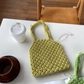Detail of light lime green hand-woven hollow straw tote bag with braided handles - Yellow (With Inner Bag)