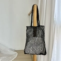 Minimalist black hollow woven tote bag with a white lining hanging on a wooden rack - Inner Bag Included / Black