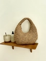 Handwoven straw cloud bag in a natural half-moon hobo style for summer beach vacations - Brown