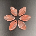 Close-up of six translucent pink leaf pendants with carved veins for jewelry making - Watermelon Red (Synthetic)