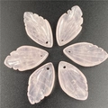 Detailed view of hand-carved rose quartz leaf pendants with delicate vein textures - Rose Quartz